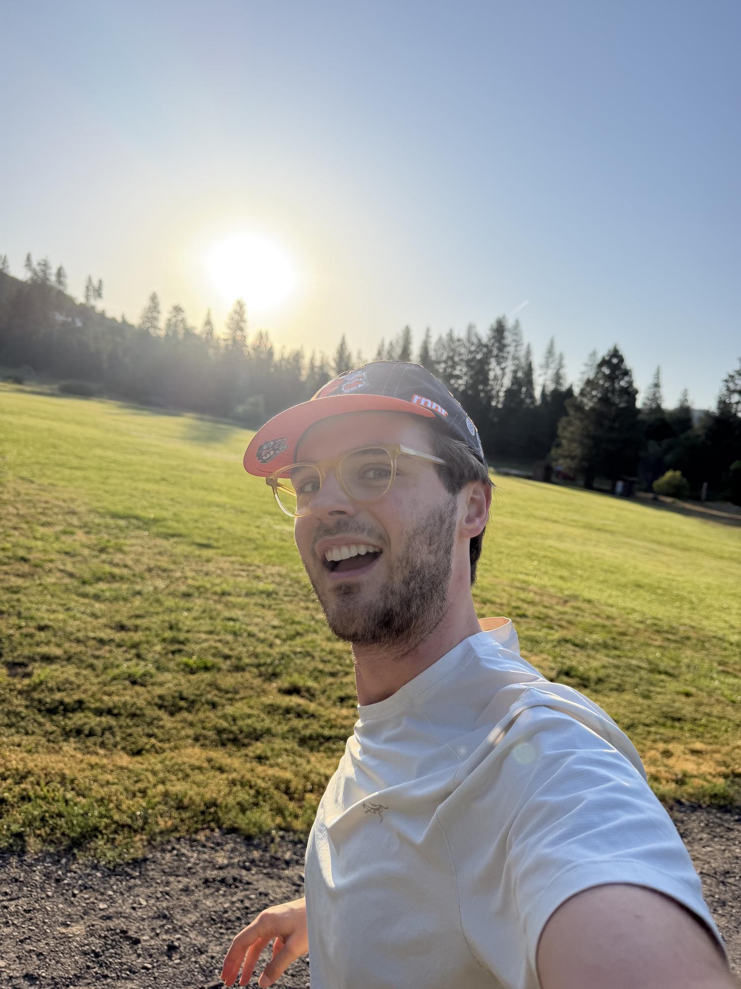 Jake Heller outdoors in a sunlit meadow at golden hour